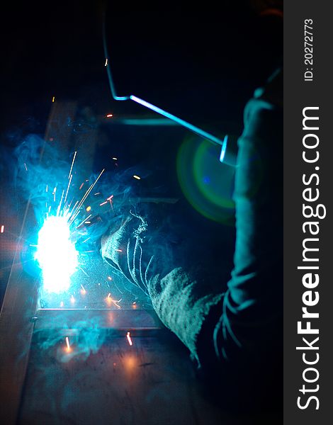 Photo of the welding process with sparks flying around. Photo of the welding process with sparks flying around