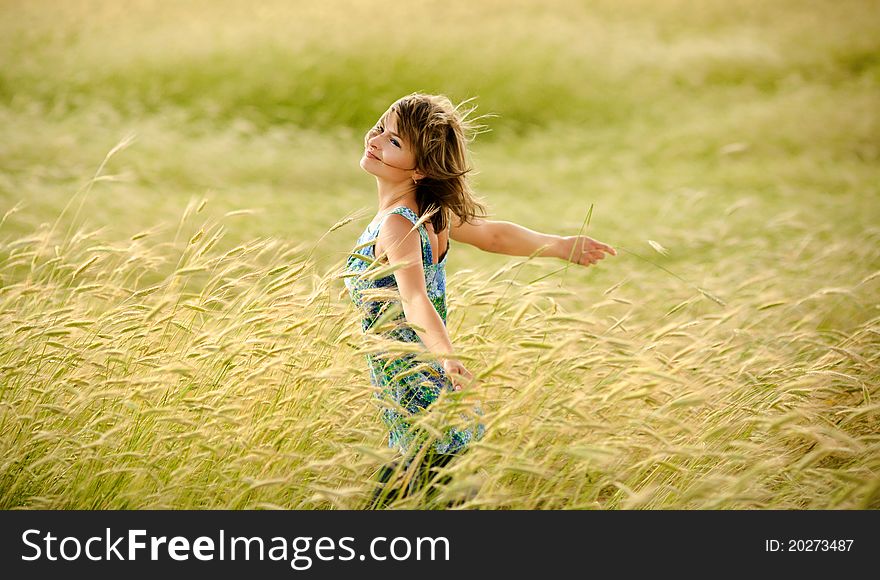 Beautiful girl smiling in a field of wheat. Beautiful girl smiling in a field of wheat
