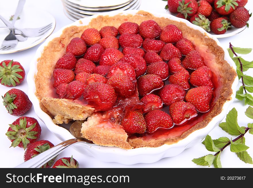 Strawberry Tart, with portion being served, on white background