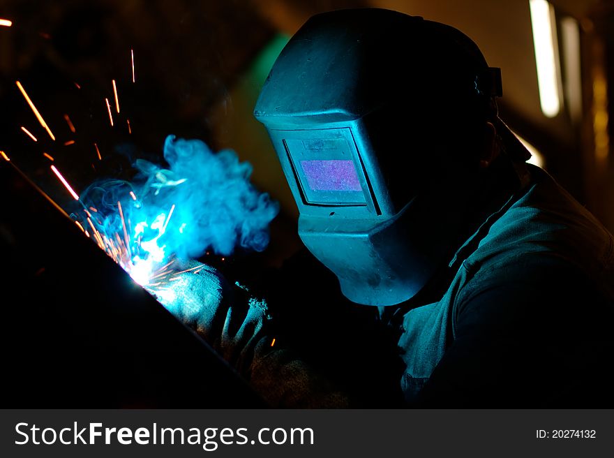 Photo of the welding process with sparks flying around. Photo of the welding process with sparks flying around