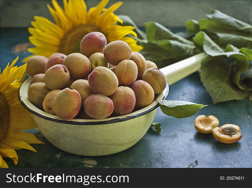 Apricots and sunflower lie on a table