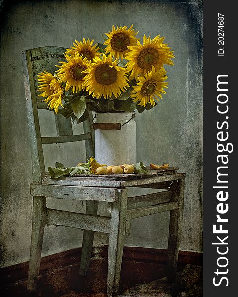 Bouquet of sunflowers and apricots on a chair