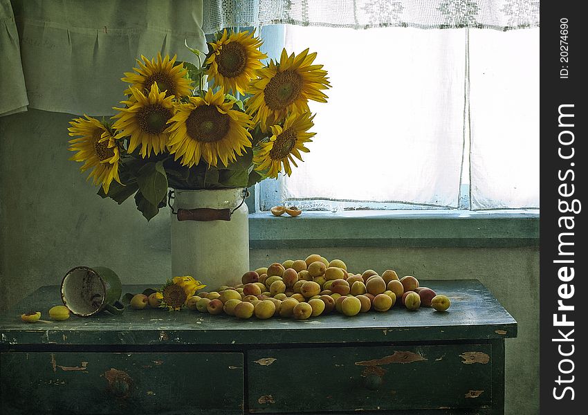 Bouquet of sunflowers and apricots on a table