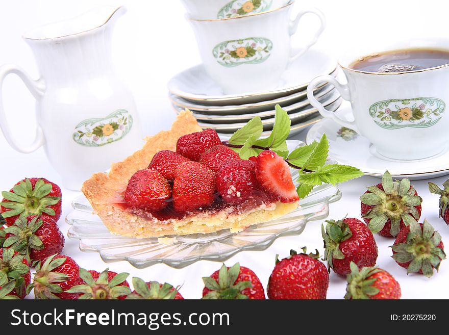 Strawberry tart, fruits, mint twig and a cup of tea. Strawberry tart, fruits, mint twig and a cup of tea