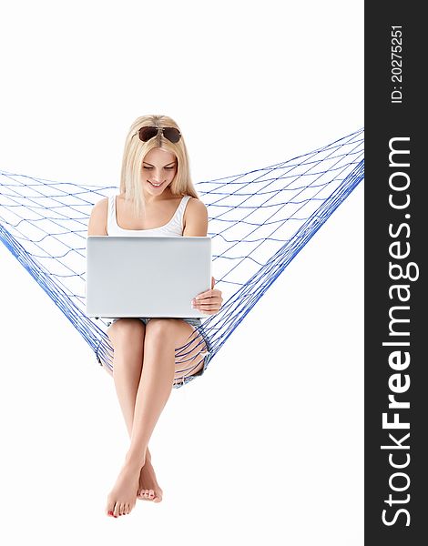 Attractive girl with laptop isolated on a hammock. Attractive girl with laptop isolated on a hammock