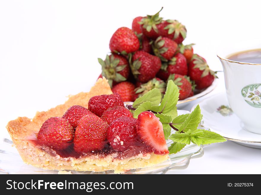 Strawberry Tart portion decorated with  mint twig and some strawberries