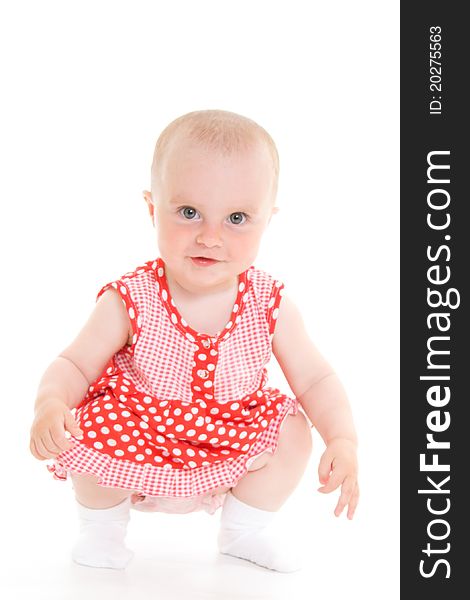 Baby in dress on a white background.