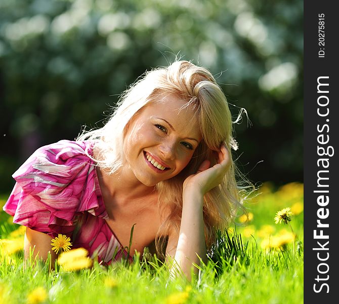 Girl lying on the field of dandelions. Girl lying on the field of dandelions