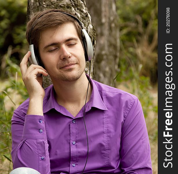 Men with headphones at the park.