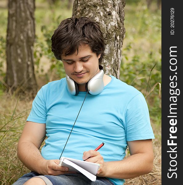 Student with notebook and headphones.