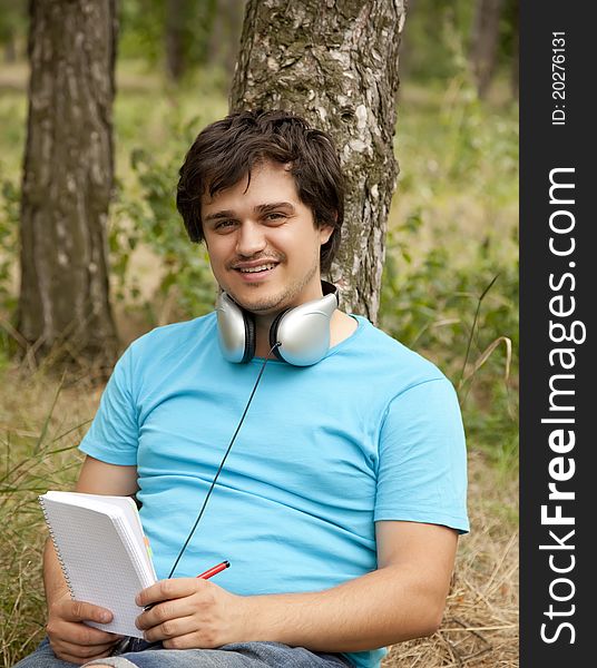 Student With Notebook And Headphones.