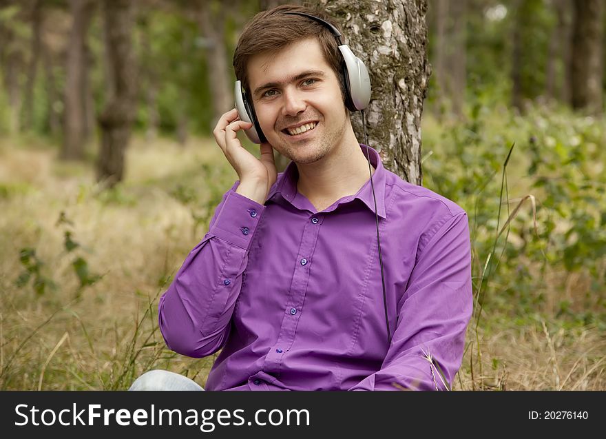 Men with headphones at the park.