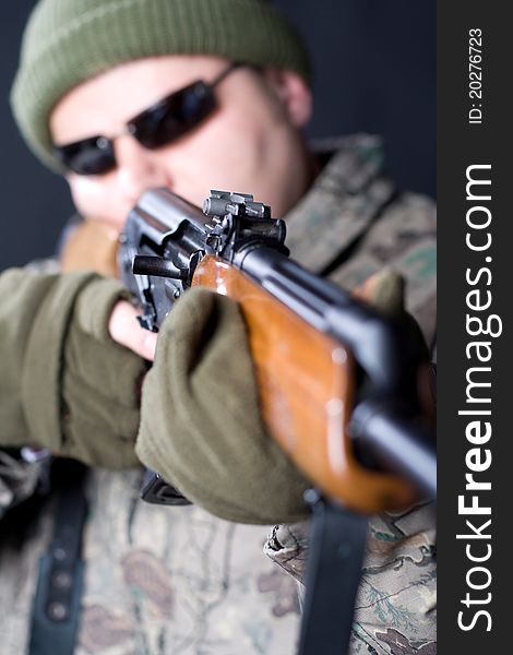 Portrait of a man with a gun on a black background. Portrait of a man with a gun on a black background.