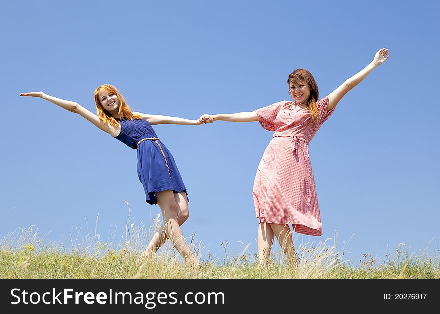 Happy girls at meadow.