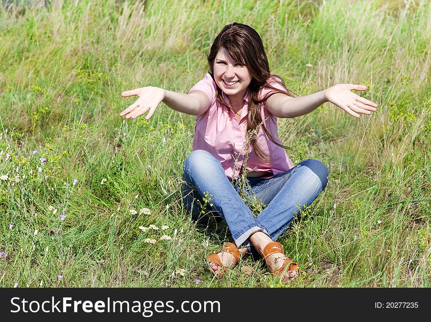 Happy girl at green grass. Outdoor photo.