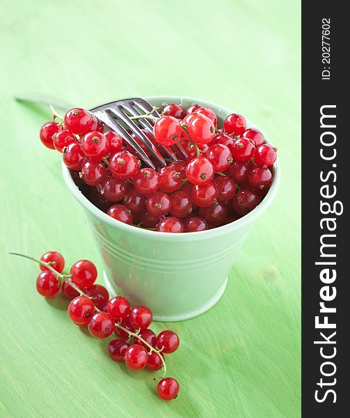 Fresh red currants in a bucket