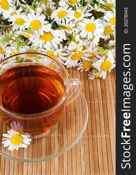 Glass cup with fragrant a camomile tea still life. Glass cup with fragrant a camomile tea still life