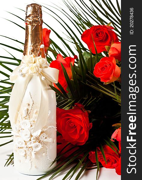 Red roses and champagne on white background