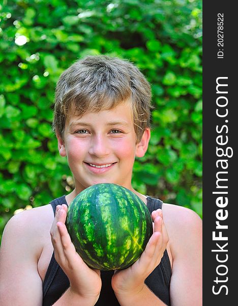 Boy holding watermelon while holding it with both hands. Boy holding watermelon while holding it with both hands