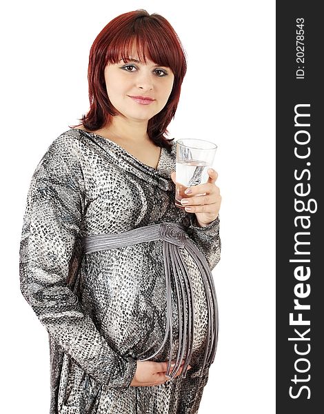 Pregnant woman holds the glass of the water