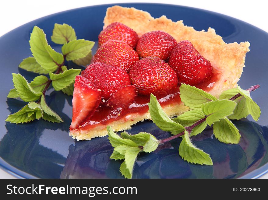 Strawberry Tart portion decorated with mint twigs