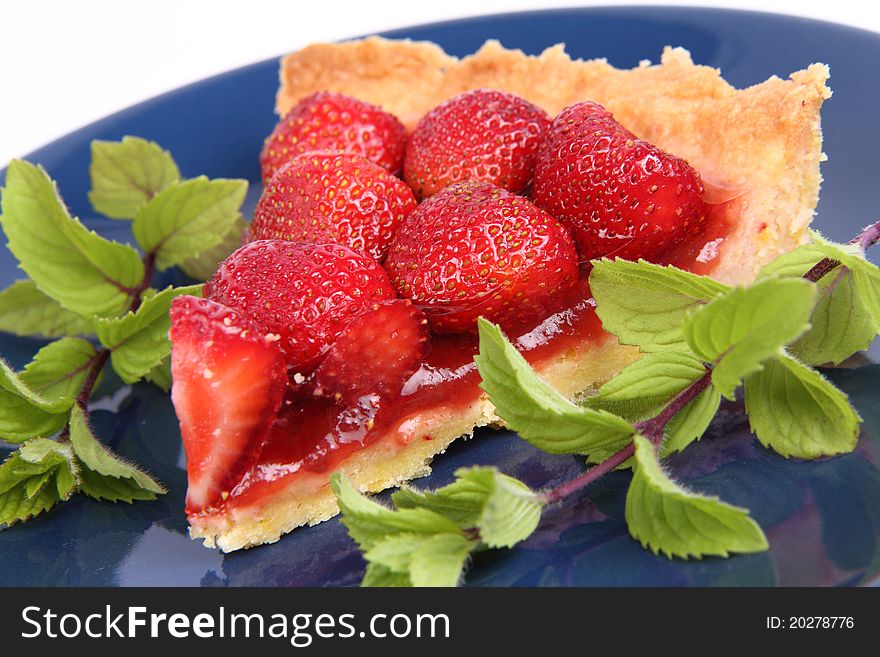 Strawberry Tart portion decorated with mint twigs