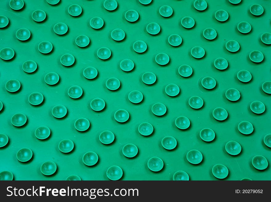 Green plastic surface with circles in pattern. Green plastic surface with circles in pattern.