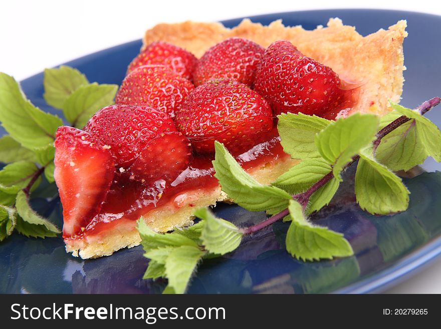 Strawberry Tart portion decorated with mint twigs