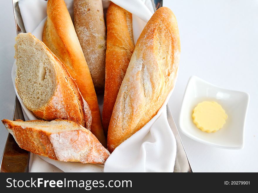 Sliced baguette with butter on the table