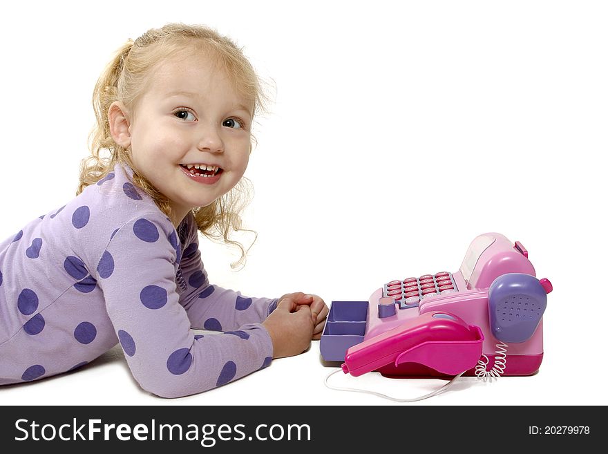 Little girl lying on the floor playing with an educational toy. Little girl lying on the floor playing with an educational toy