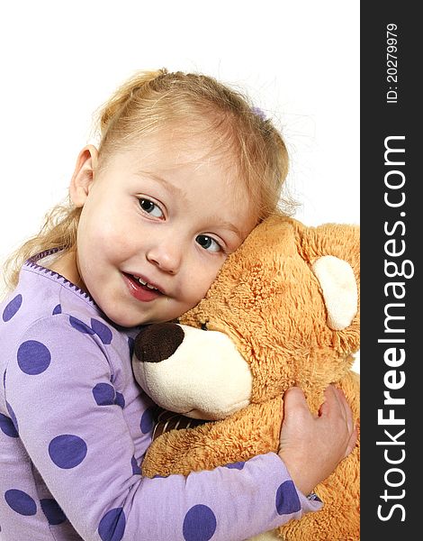 Little girl hugging a big brown teddy bear. Little girl hugging a big brown teddy bear