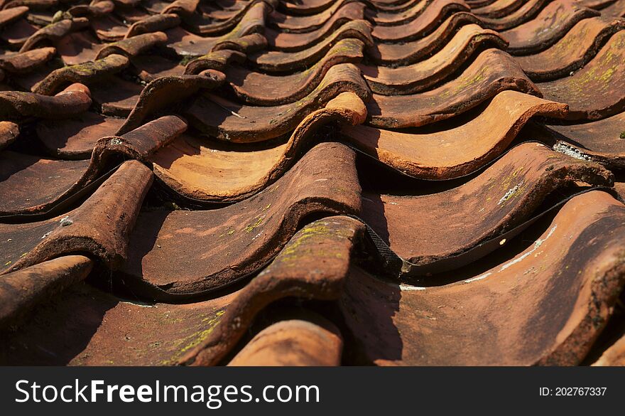 Part of a very old tiled roof.