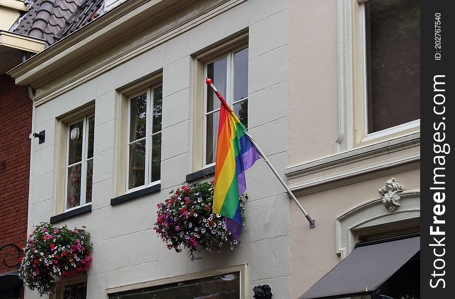 Flower baskets combined with a rainbow colored flag in Amersfoort