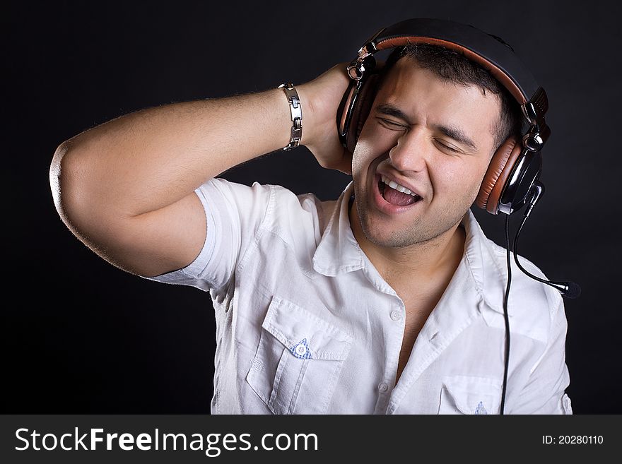 Handsome man enjoying music on headphones. Handsome man enjoying music on headphones