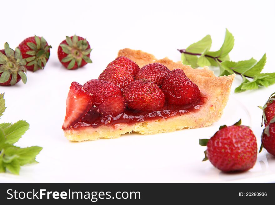 Piece of Strawberry Tart decorated with strawberries and mint