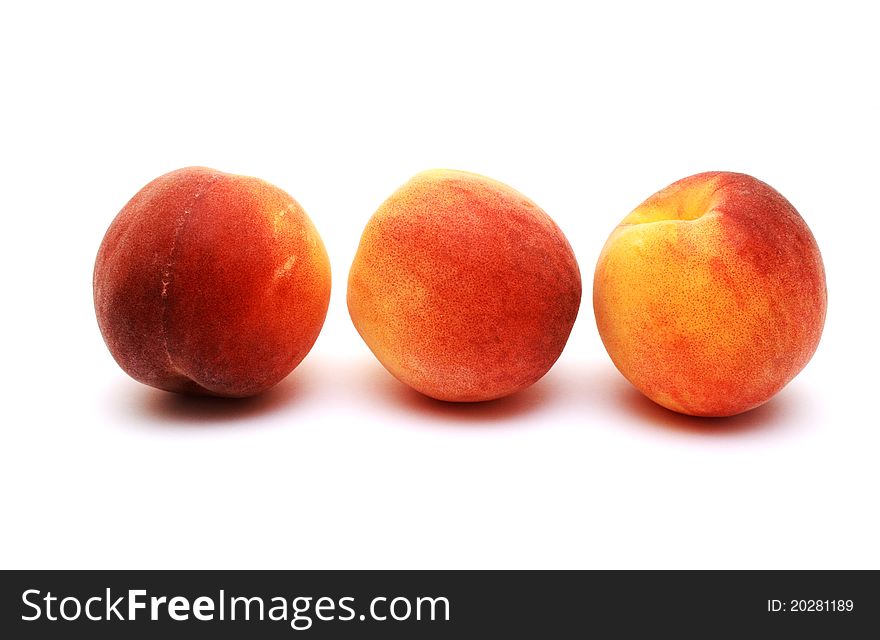 Foto of three peaches placed on white background