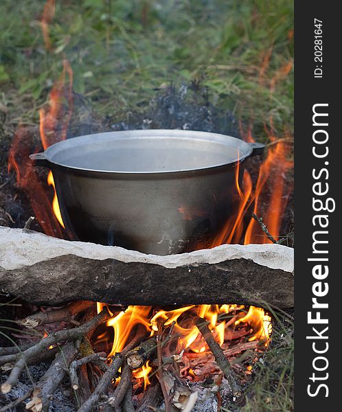 Preparing touristy food on campfire in wild camping.