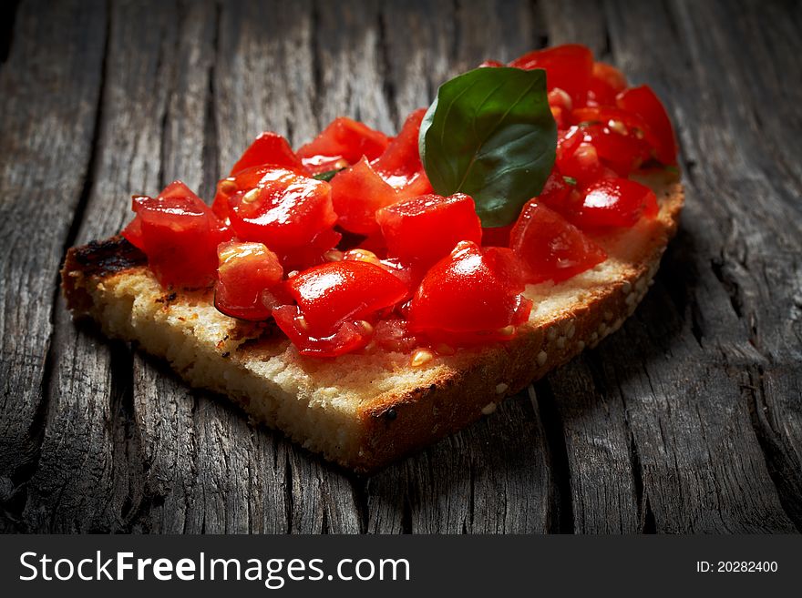 Toasted bread covered with chopped tomatoes,basil,garlic and olive oil. Toasted bread covered with chopped tomatoes,basil,garlic and olive oil