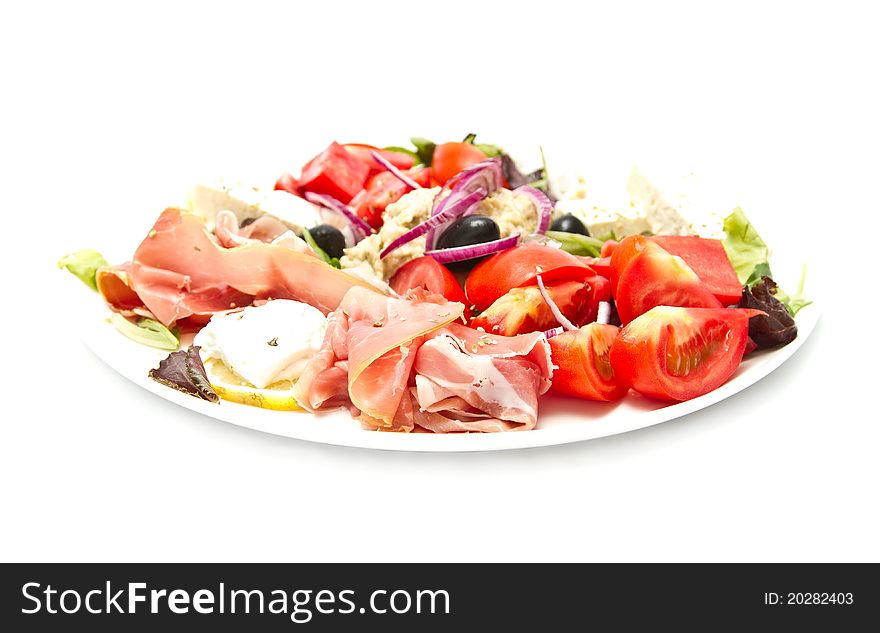 Appetizer of mixed meat, vegetables and cheese (shallow DOF)