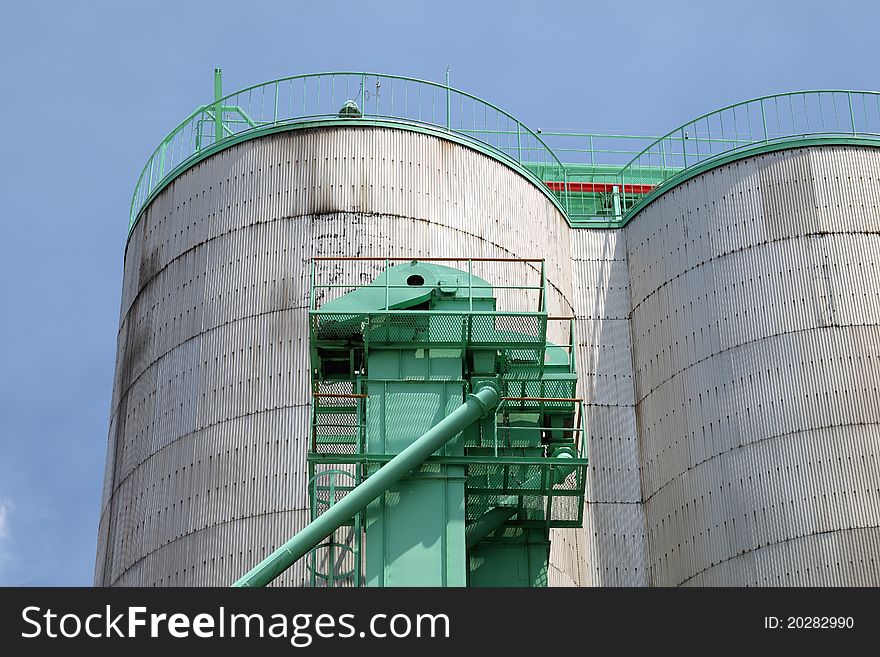 Industrial silo against the blue sky