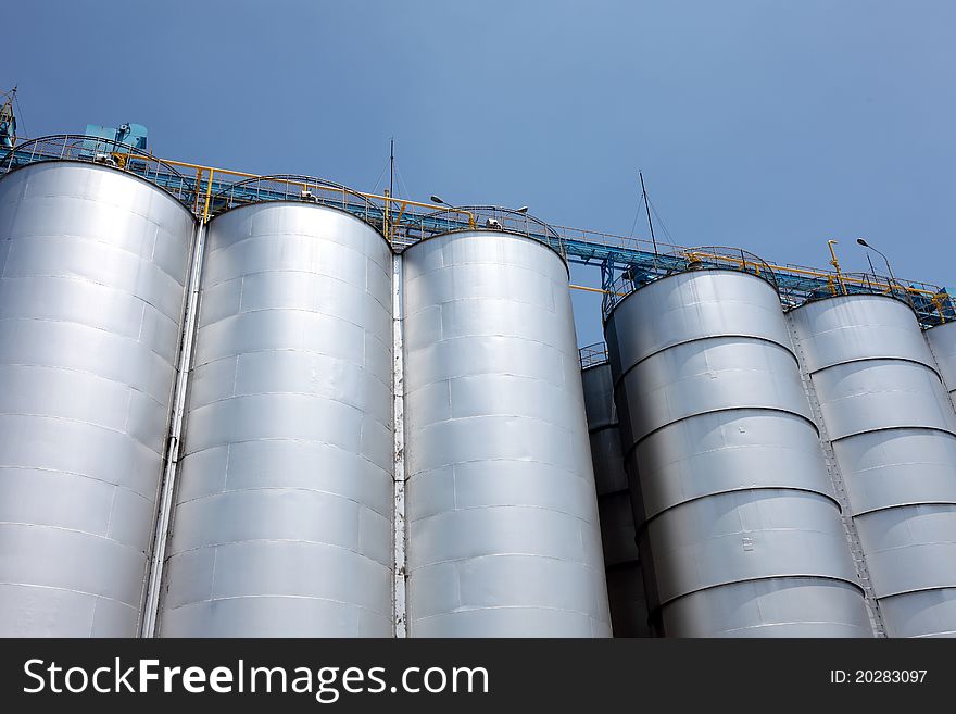 Industrial silo against the blue sky. Industrial silo against the blue sky