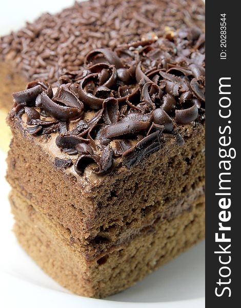 A slice of chocolate cake on white plate