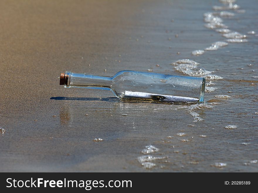A message in a bottle lying on the beach