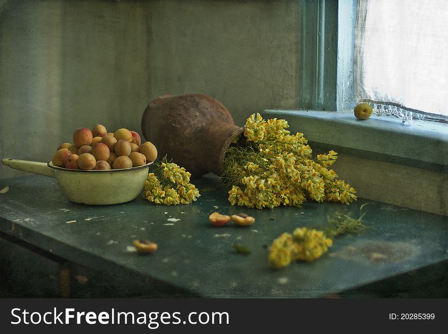 Apricots and field flowers on a table