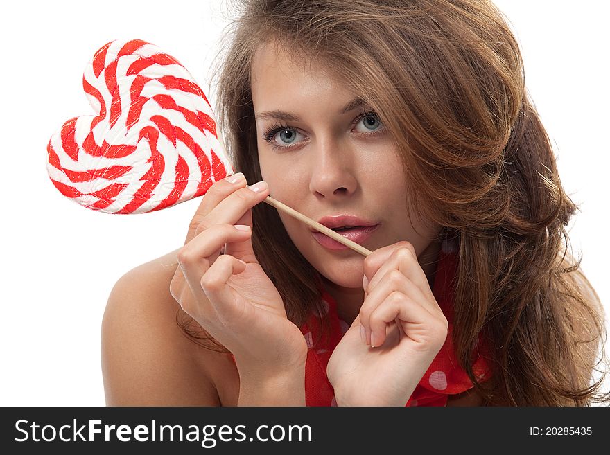 Close-up portrait of young sexy woman with heart shaped lollipop. Close-up portrait of young sexy woman with heart shaped lollipop
