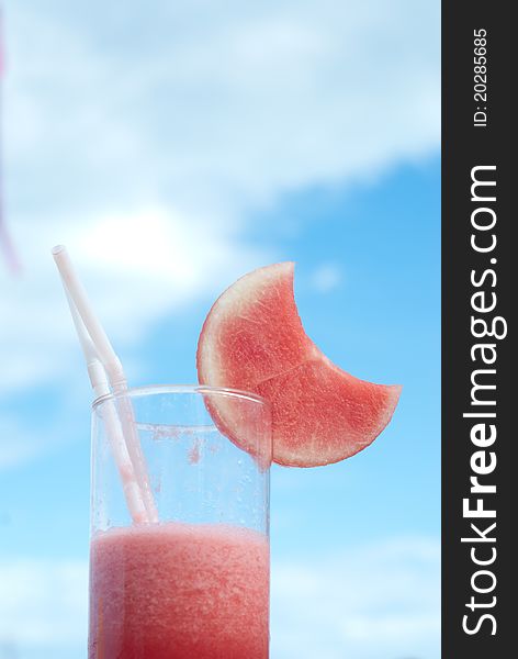 One glass of water melon juice against blue sky