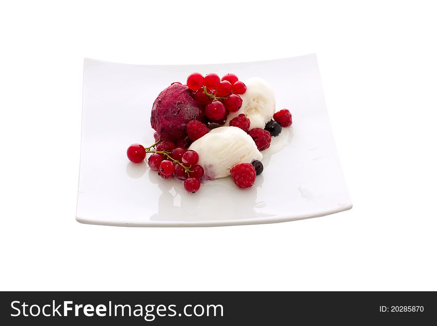 Ice cream with berries on a white plate