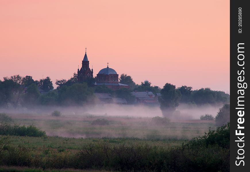 Fog over fields and orthodox church on sunrise. Fog over fields and orthodox church on sunrise.