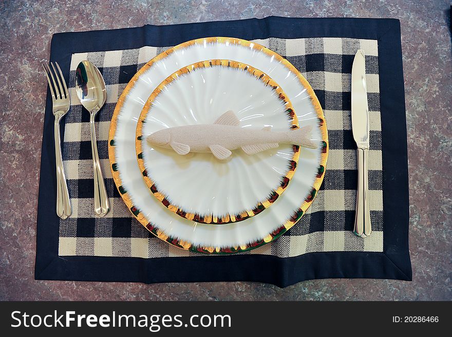 A Fish dishes model on a marble table.