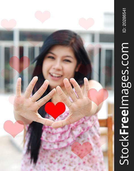 Cute young asian girl with red heart